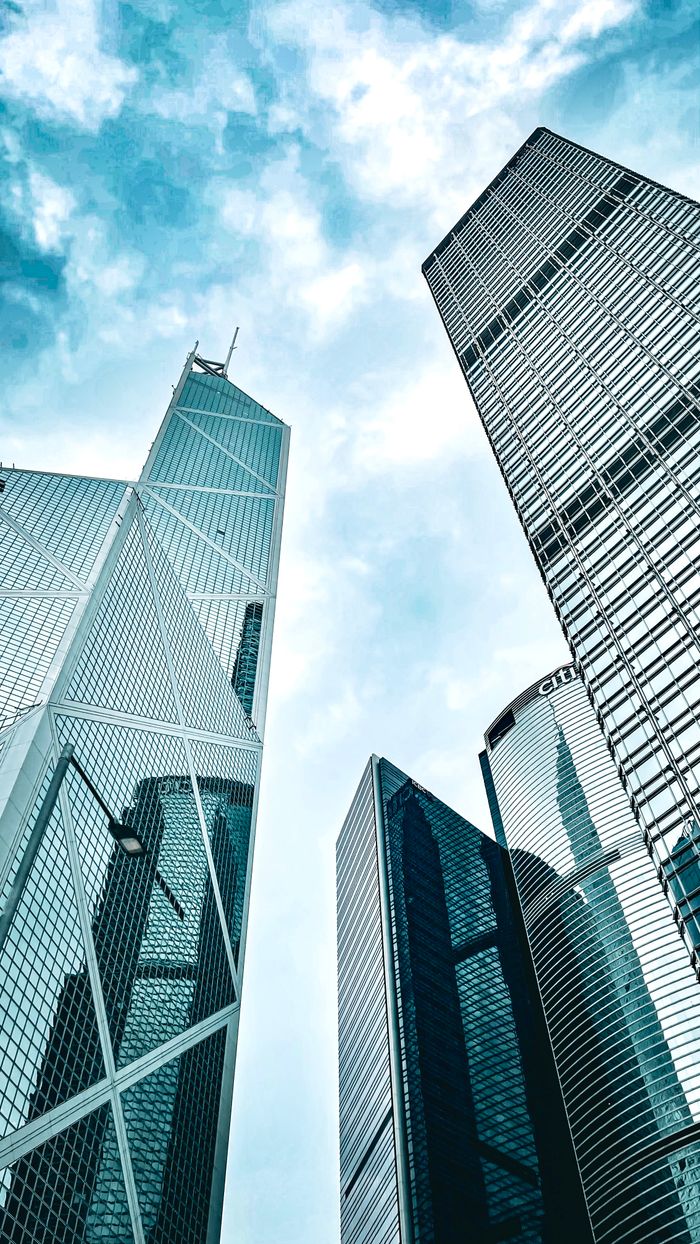 The Art of Drawing Readers In: Your attractive post title goes here Uplifting view of modern skyscrapers on Hong Kong Island against a blue sky.